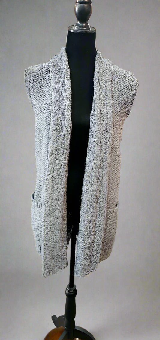Gray lace cardigan on a mannequin in a store setting