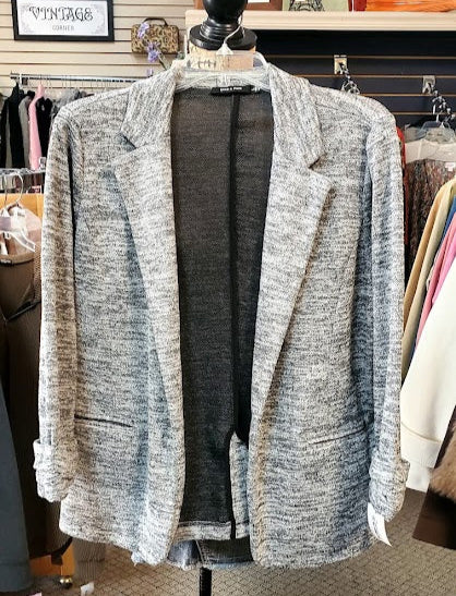 Gray textured blazer on a mannequin in a store setting