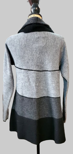 Gray and black two-tone dress on a mannequin in a store setting