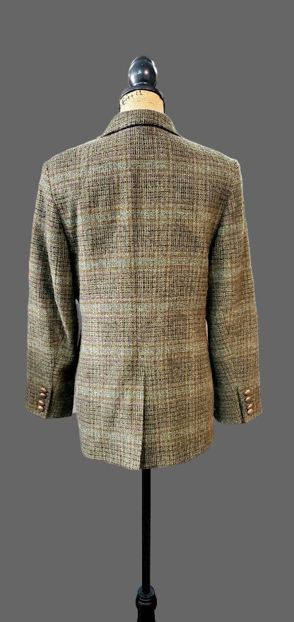 Green plaid jacket on a mannequin in a store setting with various clothing items in the background.