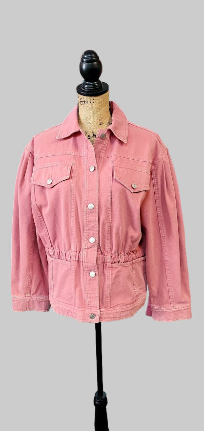 Pink jacket on a mannequin in a store setting with various items in the background.