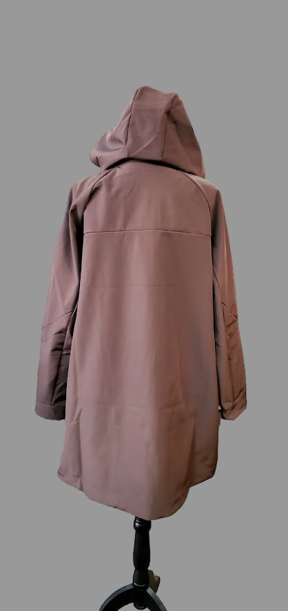 Brown coat on a mannequin in a store setting with racks of clothes in the background.