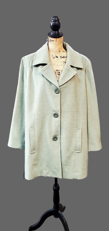 Light green coat on a mannequin in a store setting